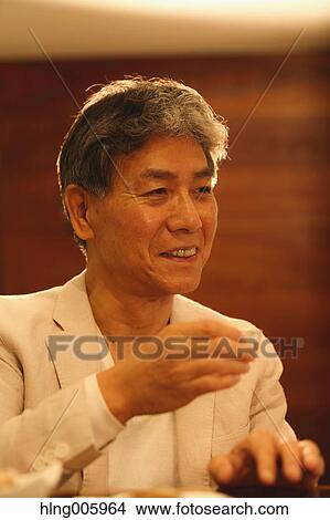Fashionable Japanese senior man drinking sake View Large Photo Image Picture - Fashionable Japanese senior man drinking sake. Fotosearch