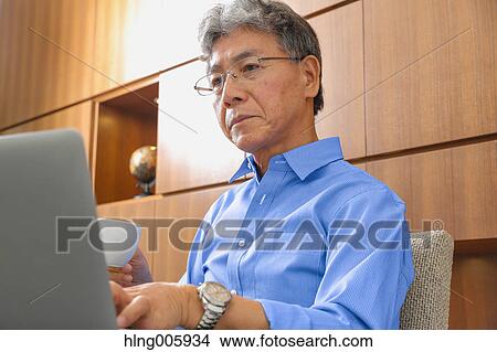 Picture - Fashionable Japanese senior man working. Fotosearch