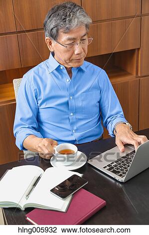 Fashionable Japanese senior man working View Large Photo Image Stock Image - Fashionable Japanese senior man working. Fotosearch