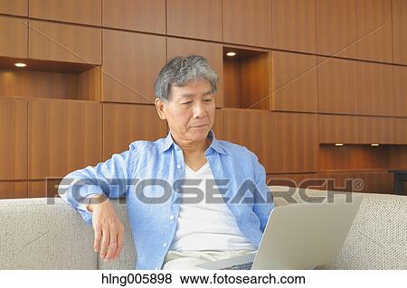Fashionable Japanese senior man working View Large Photo Image Stock Photo - Fashionable Japanese senior man working. Fotosearch