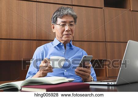Fashionable Japanese senior man working View Large Photo Image Stock Photo - Fashionable Japanese senior man working. Fotosearch