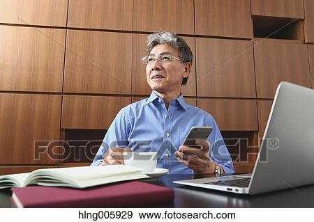 Fashionable Japanese senior man working View Large Photo Image Stock Photo - Fashionable Japanese senior man working. Fotosearch