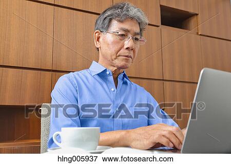 Fashionable Japanese senior man working View Large Photo Image Stock Photo - Fashionable Japanese senior man working. Fotosearch
