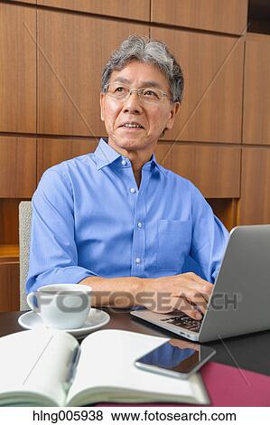 Fashionable Japanese senior man working View Large Photo Image Stock Photo - Fashionable Japanese senior man working. Fotosearch
