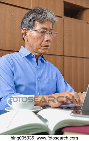 Stock Photograph - Fashionable Japanese senior man working. Fotosearch