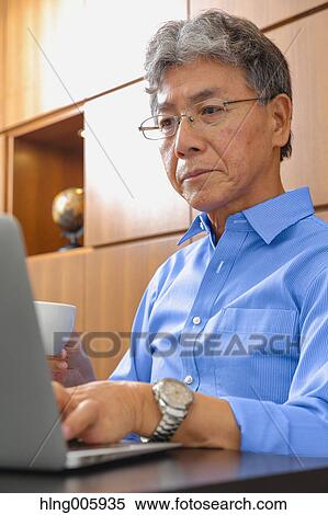 Fashionable Japanese senior man working View Large Photo Image Stock Photography - Fashionable Japanese senior man working. Fotosearch