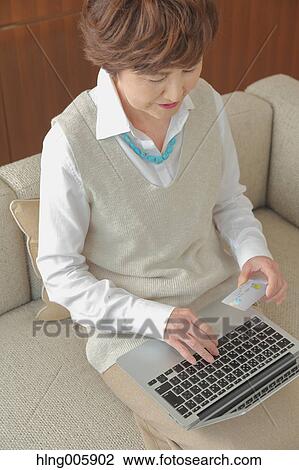 Fashionable Japanese senior woman working with laptop View Large Photo Image Stock Image - Fashionable Japanese senior woman working with laptop. Fotosearch