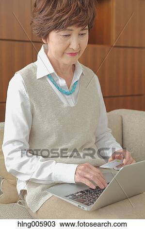 Fashionable Japanese senior woman working with laptop View Large Photo Image Stock Image - Fashionable Japanese senior woman working with laptop. Fotosearch