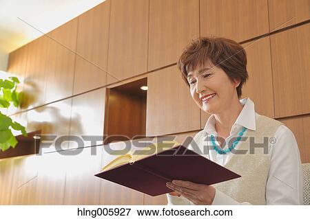 Fashionable Japanese senior woman reading book View Large Photo Image Stock Photo - Fashionable Japanese senior woman reading book. Fotosearch