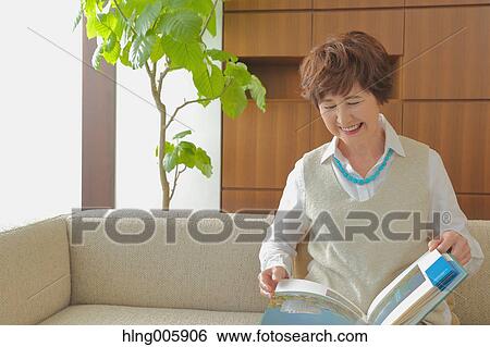 Fashionable Japanese senior woman reading book View Large Photo Image Stock Photograph - Fashionable Japanese senior woman reading book. Fotosearch