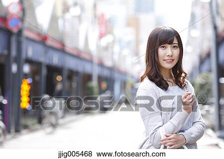 Stock Photo - Fashionable Japanese woman at a traditional shopping street, Tokyo, Japan. Fotosearch