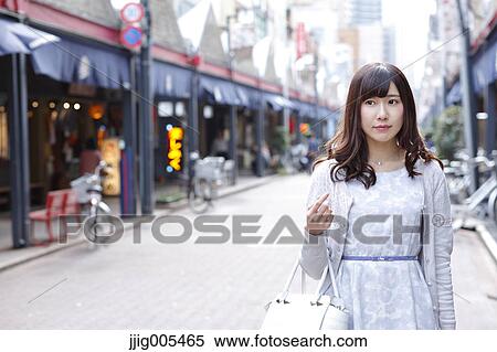 Stock Photography - Fashionable Japanese woman at a traditional shopping street, Tokyo, Japan. Fotosearch