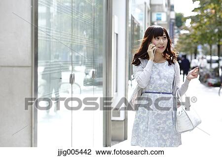 Fashionable Japanese woman on the phone in luxury Tokyo area, Tokyo, Japan View Large Photo Image Stock Image - Fashionable Japanese woman on the phone in luxury Tokyo area, Tokyo, Japan. Fotosearch