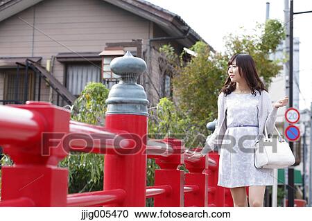Fashionable Japanese woman walking on traditional bridge, Tokyo, Japan View Large Photo Image Stock Image - Fashionable Japanese woman walking on traditional bridge, Tokyo, Japan. Fotosearch