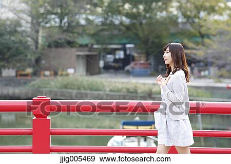 Fashionable Japanese woman walking on traditional bridge, Tokyo, Japan View Large Photo Image Stock Photo - Fashionable Japanese woman walking on traditional bridge, Tokyo, Japan. Fotosearch