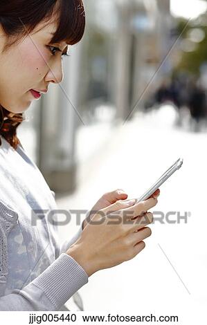 Fashionable Japanese woman with smartphone in luxury Tokyo area, Tokyo, Japan View Large Photo Image Stock Image - Fashionable Japanese woman with smartphone in luxury Tokyo area, Tokyo, Japan. Fotosearch