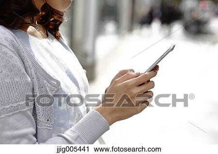 Fashionable Japanese woman with smartphone in luxury Tokyo area, Tokyo, Japan View Large Photo Image Stock Image - Fashionable Japanese woman with smartphone in luxury Tokyo area, Tokyo, Japan. Fotosearch