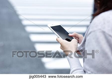Fashionable Japanese woman with smartphone in luxury Tokyo area, Tokyo, Japan View Large Photo Image Stock Image - Fashionable Japanese woman with smartphone in luxury Tokyo area, Tokyo, Japan. Fotosearch