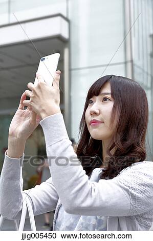 Fashionable Japanese woman with smartphone in luxury Tokyo area, Tokyo, Japan View Large Photo Image Stock Image - Fashionable Japanese woman with smartphone in luxury Tokyo area, Tokyo, Japan. Fotosearch