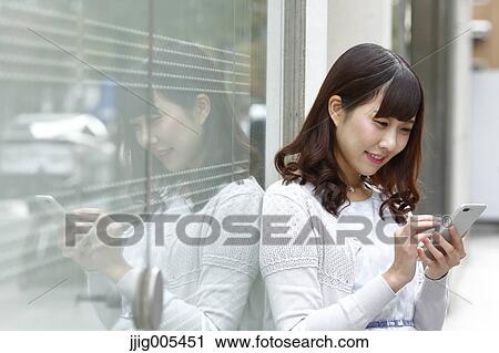 Fashionable Japanese woman with smartphone in luxury Tokyo area, Tokyo, Japan View Large Photo Image Stock Image - Fashionable Japanese woman with smartphone in luxury Tokyo area, Tokyo, Japan. Fotosearch