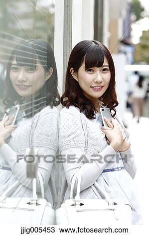 Fashionable Japanese woman with smartphone in luxury Tokyo area, Tokyo, Japan View Large Photo Image Stock Image - Fashionable Japanese woman with smartphone in luxury Tokyo area, Tokyo, Japan. Fotosearch