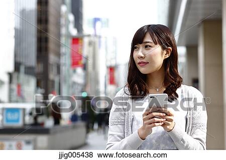 Fashionable Japanese woman with smartphone in luxury Tokyo area, Tokyo, Japan View Large Photo Image Stock Photo - Fashionable Japanese woman with smartphone in luxury Tokyo area, Tokyo, Japan. Fotosearch