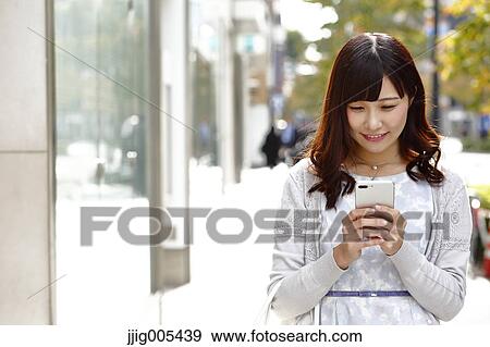 Fashionable Japanese woman with smartphone in luxury Tokyo area, Tokyo, Japan View Large Photo Image Stock Photo - Fashionable Japanese woman with smartphone in luxury Tokyo area, Tokyo, Japan. Fotosearch