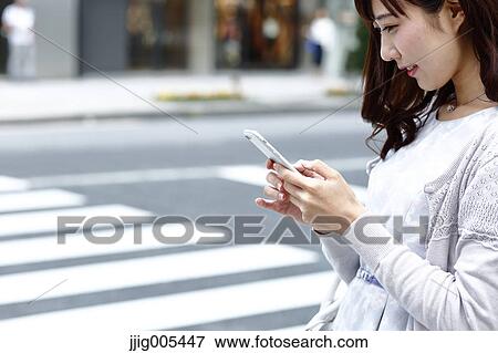Fashionable Japanese woman with smartphone in luxury Tokyo area, Tokyo, Japan View Large Photo Image Stock Photo - Fashionable Japanese woman with smartphone in luxury Tokyo area, Tokyo, Japan. Fotosearch