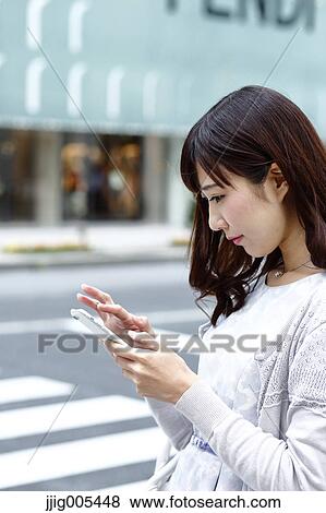 Fashionable Japanese woman with smartphone in luxury Tokyo area, Tokyo, Japan View Large Photo Image Stock Photo - Fashionable Japanese woman with smartphone in luxury Tokyo area, Tokyo, Japan. Fotosearch