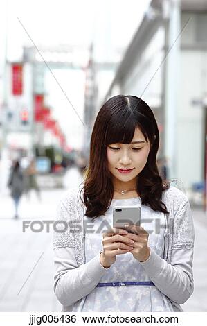 Fashionable Japanese woman with smartphone in luxury Tokyo area, Tokyo, Japan View Large Photo Image Stock Photograph - Fashionable Japanese woman with smartphone in luxury Tokyo area, Tokyo, Japan. Fotosearch