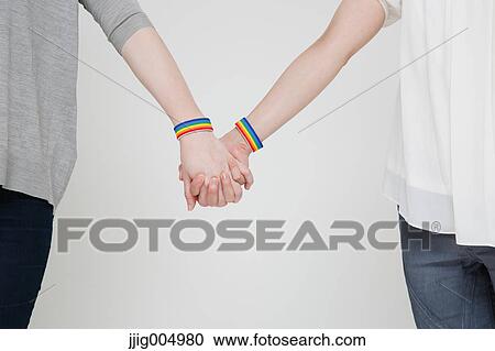 Female couple holding hands View Large Photo Image Stock Image - Female couple holding hands. Fotosearch