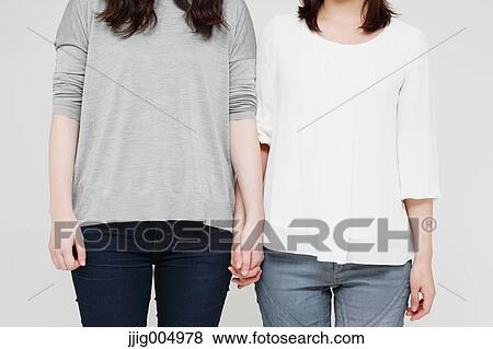 Female couple holding hands View Large Photo Image Stock Photo - Female couple holding hands. Fotosearch
