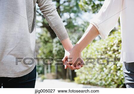 Stock Photo - Female couple holding hands. Fotosearch