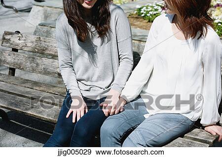 Female couple holding hands View Large Photo Image Stock Photo - Female couple holding hands. Fotosearch