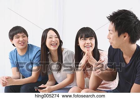 Picture - Group of Japanese supporters in the living room. Fotosearch