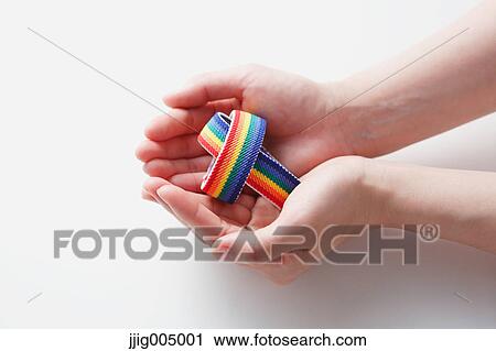 Hands holding rainbow wristbands View Large Photo Image Stock Image - Hands holding rainbow wristbands. Fotosearch