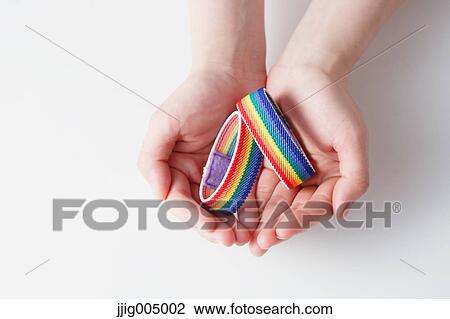 Hands holding rainbow wristbands View Large Photo Image Stock Image - Hands holding rainbow wristbands. Fotosearch