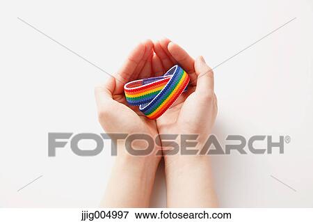 Hands holding rainbow wristbands View Large Photo Image Stock Photo - Hands holding rainbow wristbands. Fotosearch