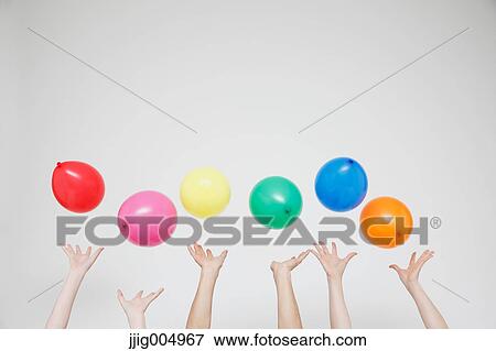 Stock Photo - Hands with balloons. Fotosearch