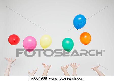 Stock Photo - Hands with balloons. Fotosearch