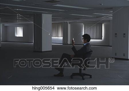 Japanese businessman in empty office View Large Photo Image Picture - Japanese businessman in empty office. Fotosearch
