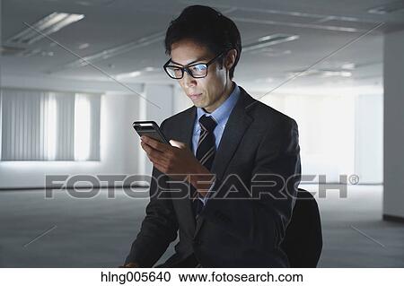 Japanese businessman in empty office View Large Photo Image Stock Image - Japanese businessman in empty office. Fotosearch
