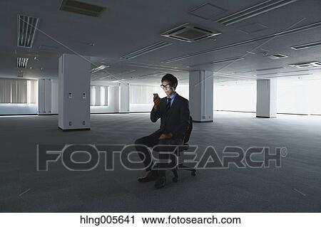 Japanese businessman in empty office View Large Photo Image Stock Image - Japanese businessman in empty office. Fotosearch