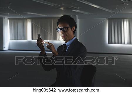 Stock Image - Japanese businessman in empty office. Fotosearch