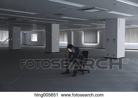 Japanese businessman in empty office View Large Photo Image Stock Image - Japanese businessman in empty office. Fotosearch