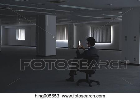 Japanese businessman in empty office View Large Photo Image Stock Image - Japanese businessman in empty office. Fotosearch