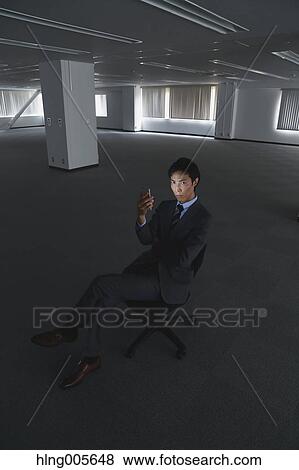 Japanese businessman in empty office View Large Photo Image Stock Photo - Japanese businessman in empty office. Fotosearch