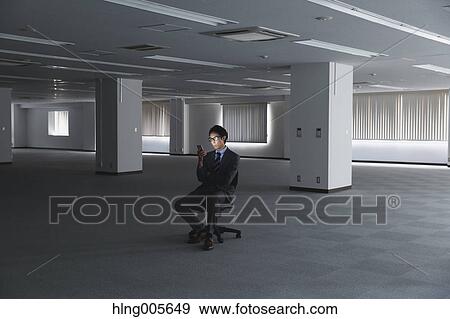 Japanese businessman in empty office View Large Photo Image Stock Photo - Japanese businessman in empty office. Fotosearch