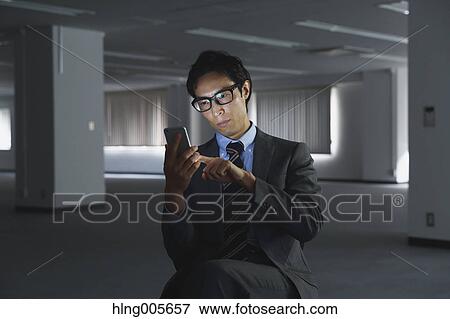 Japanese businessman in empty office View Large Photo Image Stock Photo - Japanese businessman in empty office. Fotosearch