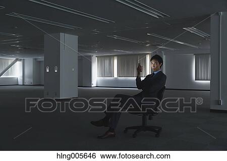 Japanese businessman in empty office View Large Photo Image Stock Photograph - Japanese businessman in empty office. Fotosearch